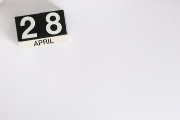 April 28th. Tax Day. Image of april 28 wooden color calendar on white background.  Spring day, empty space for text