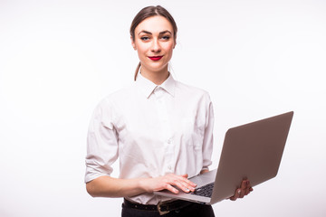 Happy young woman holding laptop and looking at camera over white background