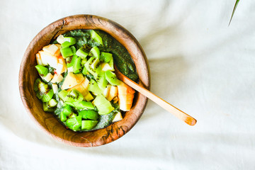 Green smoothies bowl with apple and kiwi, healthy raw breakfast