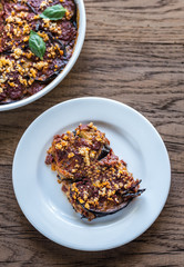 Dish and portion of parmigiana di melanzane