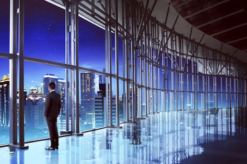 Fototapeta premium Successful manager looking the city from his office