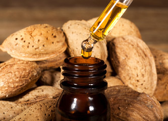 Almond oil on an old wooden background