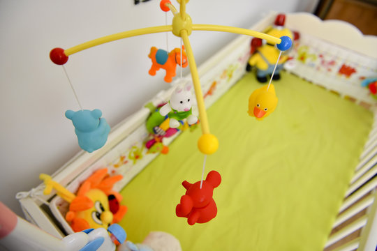 Baby cot with colorful toys hanging