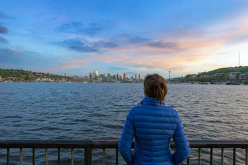 Woman Watching Sunset Over Seattle Skyline in Washington State