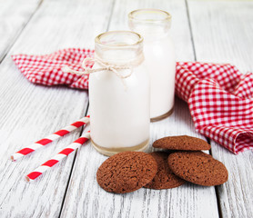 oatmeal cookies and bottles of milk