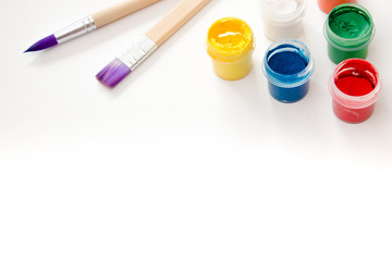 Watercolor paint and brushes isolated on white background