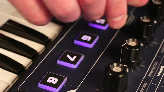 young hands of man playing synthesizer