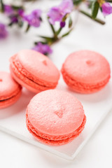 Bright macaroons on the wooden background. Shallow depth of field.