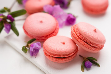 Bright macaroons on the wooden background. Shallow depth of field.