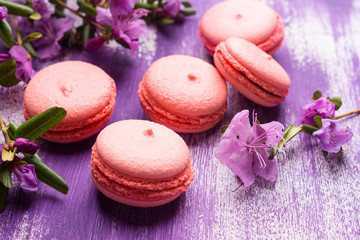 Bright macaroons on the wooden background. Shallow depth of field.