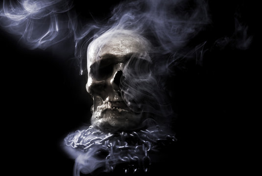 front of real skull in abstract smoke
