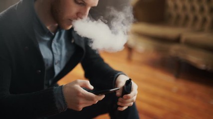 Man using an advanced personal vaporizer or e-cigarette