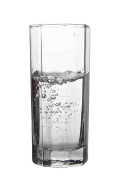 Water with air bubbles in a tall glass isolated on white backgro