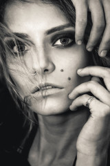 Obraz premium Close-up black and white portrait of beautiful stylish girl model with trendy make-up smoky eyes