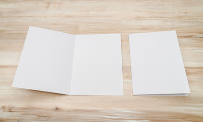 Bifold white template paper on wood texture