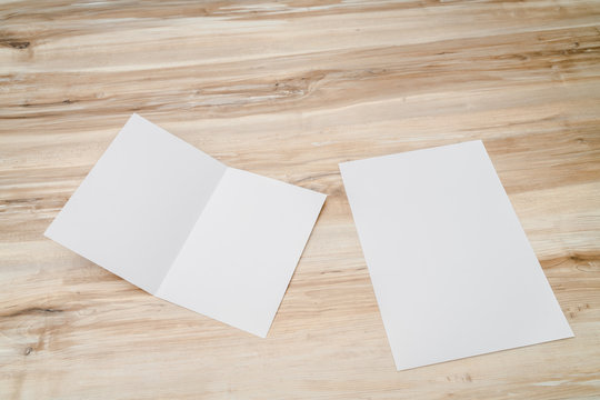 Bifold white template paper on wood texture