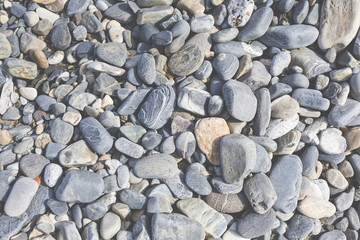 Sea stones or the wet smooth black stone on the beach as backgro