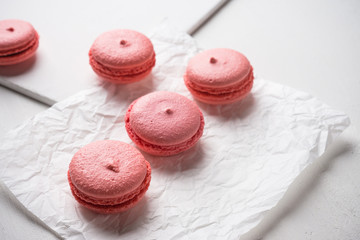 Bright macaroons on the wooden background