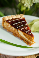 a piece of cake with fruit jam, topped with whipped cream on a white plate