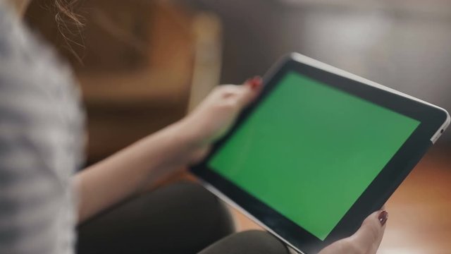 Mixed race woman laughing with tablet