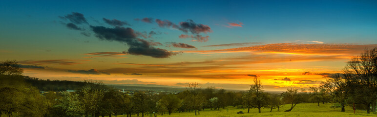Panoramic image of colorful sunset in the countryside
