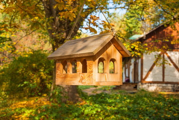 Wooden houses for birds in autumn park