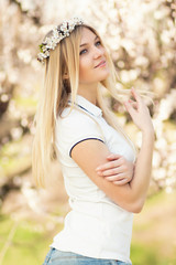 young girl in a wreath of flowers with apricot