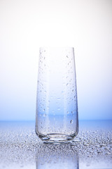 Empty drinking glass in drops of water