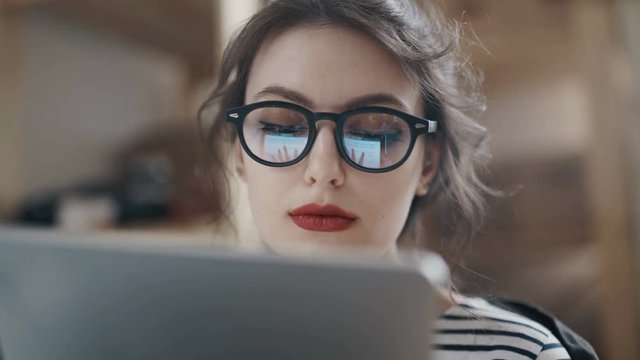 Stylish brunette working from home in her home office