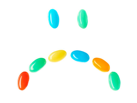 Upset sad smiley made of multicolored candies