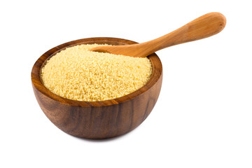 Raw couscous in a wooden bowl