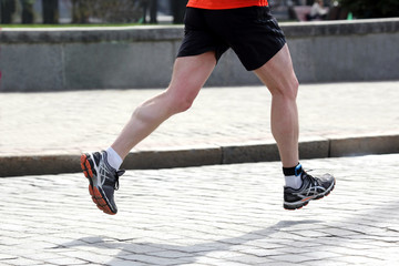 Fototapeta na wymiar feet running athlete on a marathon distance