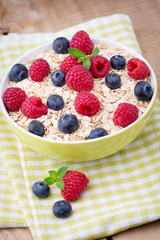 Oatmeal porridge with berries. Raspberries and blueberries.