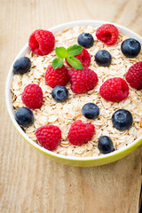 Oatmeal porridge with berries. Raspberries and blueberries.