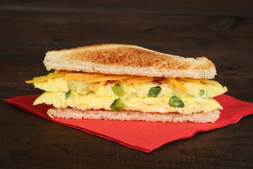 toasted western sandwich on red napkin