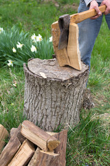 Hand slicing wood by axe