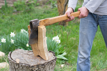 Hand slicing wood by axe