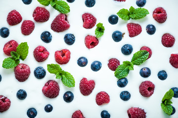 Food background, raspberries and blueberies on yoghurt