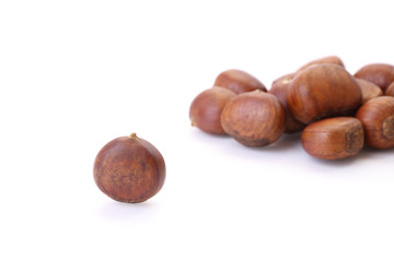 Roasted chestnuts on white floor.