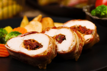 Delicious chicken rolls with dried tomatoes and mozzarella.