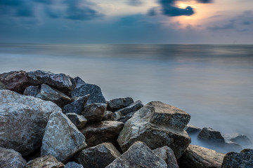 Fototapeta na wymiar Smooth sea beach and Rocks