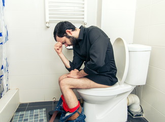 man having problems in the toilet