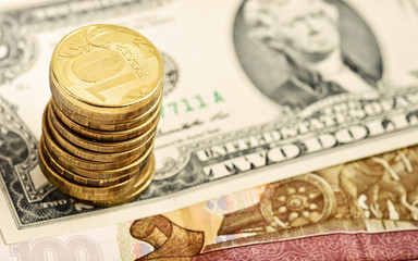 Stack of coins on banknotes