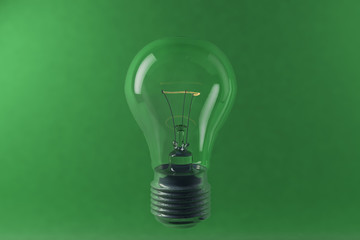 Digital 3D illustration of electric bulb on the green background
