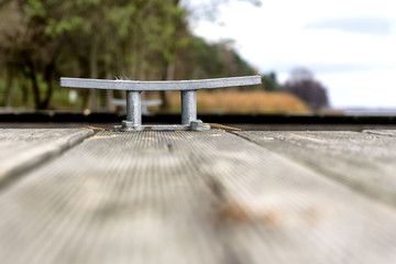 Wooden pier with cleat, nobody. Selective focus