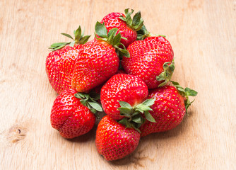 Red fresh strawberry fruits on wooden table.