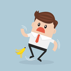 Businessman slipping on a banana peel. vector. flat design