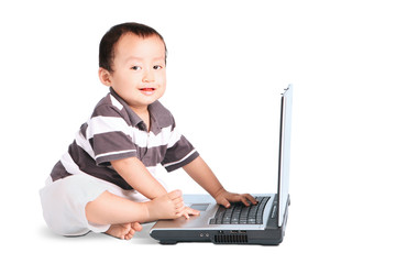 Cute baby and laptop computer