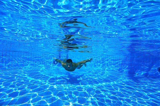 Man Dives Into The Pool Underwater Photo