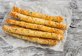Homemade cheese bread sticks on a light wooden background